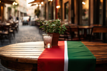 The Italian tricolor flag on a sidewalk cafe table in Rome. Concept of culinary delights and...