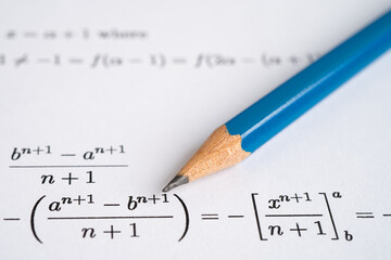 Pencil on mathematic formula exercise test paper in education school.