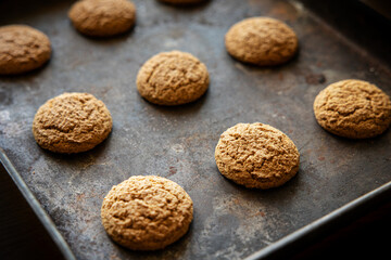 Oatmeal cookies on baking sheet. Fresh sweet pastries for tea. Homemade oatmeal sweets.
