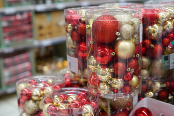 Fototapeta na wymiar Christmas ornaments. Christmas market store - Colorful decorations red and golden balls in boxes