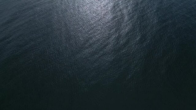 Aerial view of the sea surface reflecting the sun