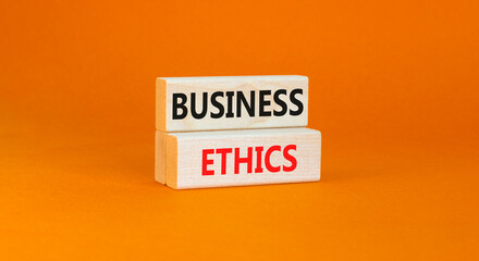 Business ethics symbol. Concept words Business ethics on beautiful wooden blocks. Beautiful orange...