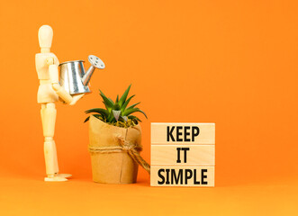 Keep it simple symbol. Concept word Keep it simple on beautiful wooden block. Businessman model....