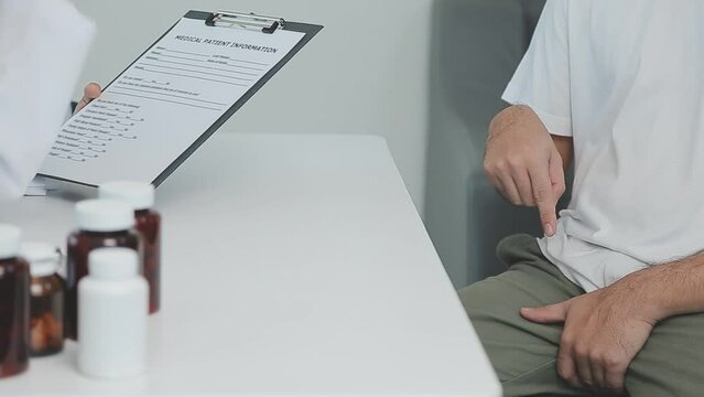 Man with benign prostatic hyperplasia being examined and consulting Asian female doctor and The doctor will ask about the patient's illness and give health advice.