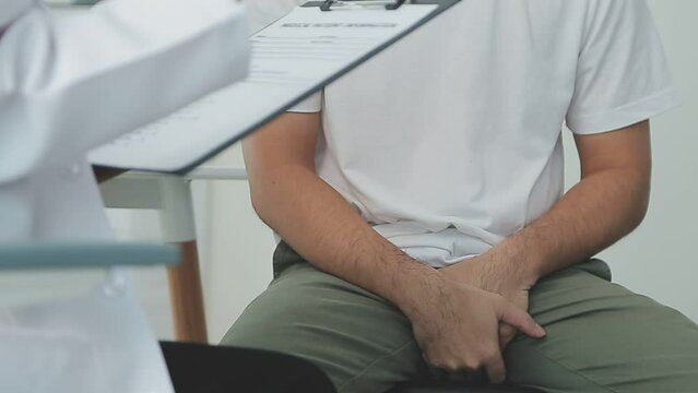 Man with benign prostatic hyperplasia being examined and consulting Asian female doctor and The doctor will ask about the patient's illness and give health advice.