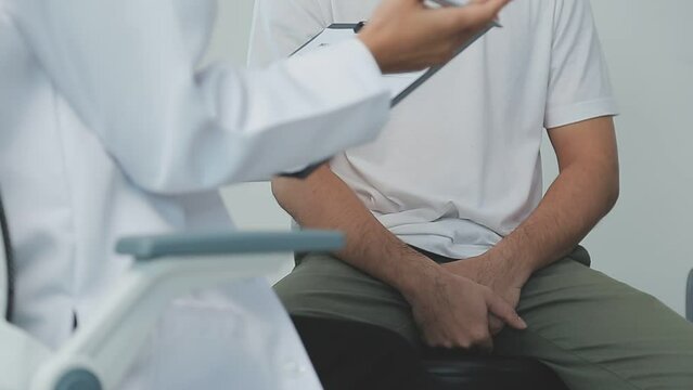 Man with benign prostatic hyperplasia being examined and consulting Asian female doctor and The doctor will ask about the patient's illness and give health advice.