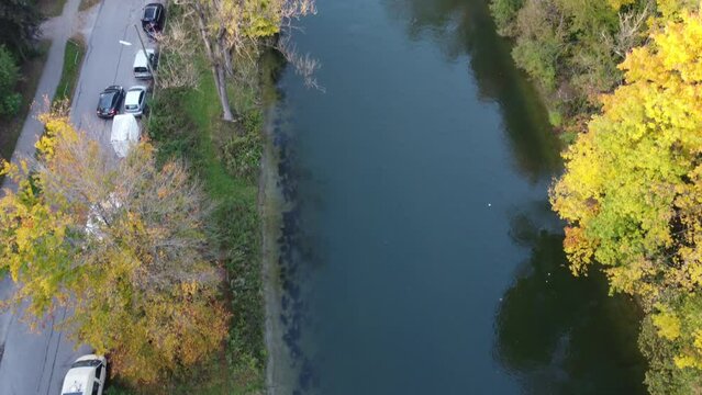 Aerial views of autumn in Munich. Isar river seen from above with colorful trees nearby