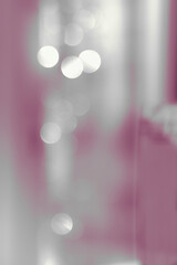 Blurred background with bokeh bubbles and pinkish tints