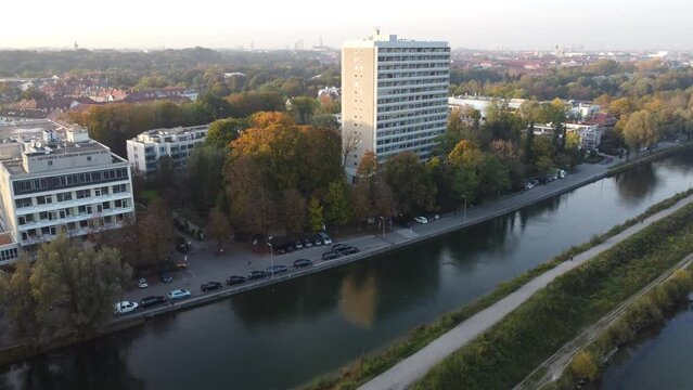 Aerial views of autumn in Munich. Isar river seen from above with colorful trees nearby