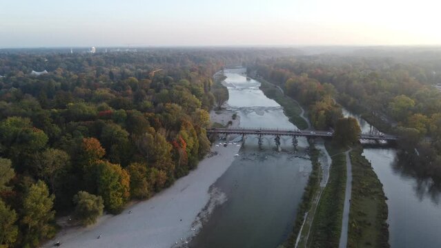 Aerial views of autumn in Munich. Isar river seen from above with colorful trees nearby