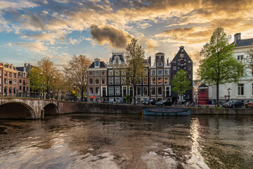 Amsterdam Netherlands, sunset city skyline at canal waterfront - obrazy, fototapety, plakaty