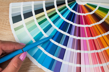Graphic designer choosing color from sampler - obrazy, fototapety, plakaty
