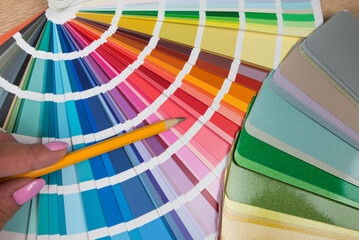Graphic designer choosing color from sampler