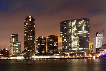 City buildings of Rotterdam at night in front of the sea, the Netherlands