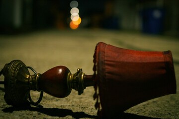 Closeup of an old red turned lamp against blurred background