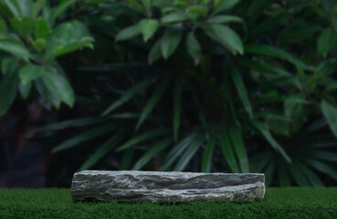 Obraz premium Stone tabletop counter podium floor in outdoor tropical garden forest blurred green palm leaf plant nature background.Natural product placement pedestal stand display,summer jungle paradise concept.