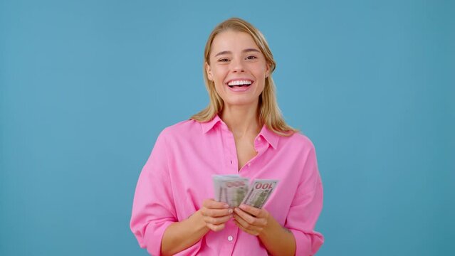Wealthy female counts money and dreams of going on holiday