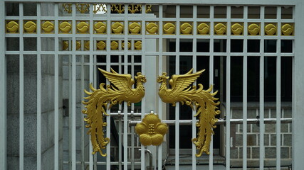 Golden phoenix and Rose of Sharon pattern decoration at the entrance gate of the Blue House in Korea