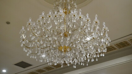 Luxurious white lamp chandelier hanging from the ceiling