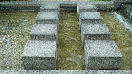 Stone stepping stones in the public park fountain