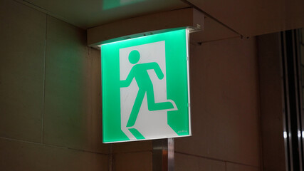 Square emergency exit lamp on the hallway ceiling