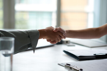HR manager greeting applicant, shaking her hand before meeting