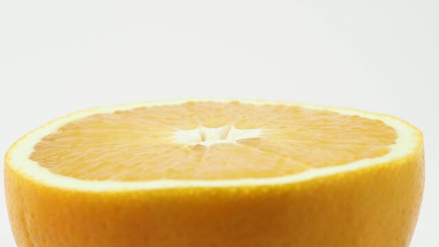 Ripe oranges rotate on a white background. Oranges close-up on white.