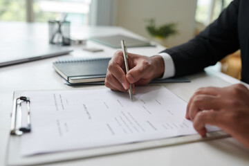 New employee signing labor contract after job interview