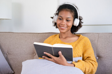 Woman enjoys book and music in modern abode.
