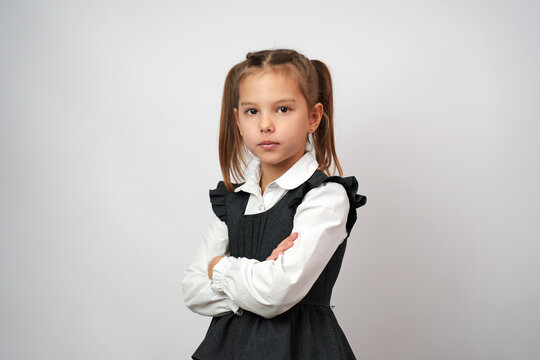 Portrait of cute little girl standing with crossed arms