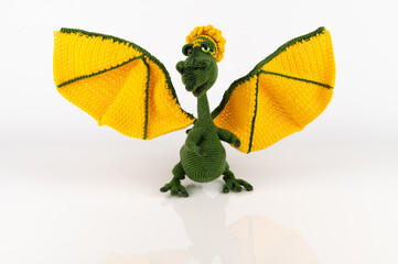A green female dragon with large yellow wings