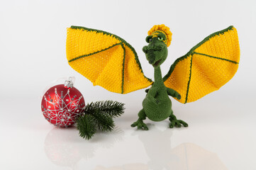 A green female dragon with large yellow wings