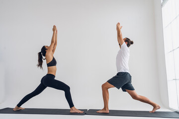 Health,lifestyle and exercise concept.woman sports wear exercising with a yoga instructor man...