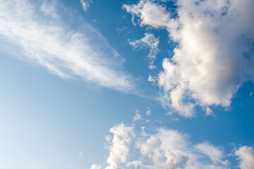 Unusual white striped wavy clouds in a bright blue sky. Heavenly background for your photos. Perfect Sky photo