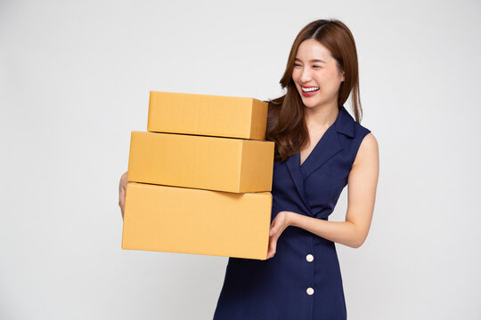 Happy Young Asian businesswoman smile and holding package parcel box isolated on white background, Delivery courier and shipping service concept