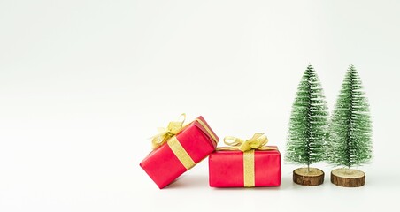 Banner, Christmas card, boxes with gifts and green fir trees on a white background, a symbol of Christmas.  Space for copying text, advertising.  Christmas and New Year holiday concept.