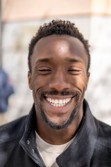 Frontal shot of black-skinned man smiling
