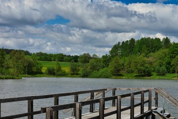 there is a wooden dock in the water that extends to the lake