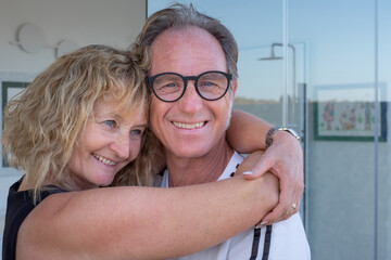 Portrait of happy mature middle aged family couple smiling embracing, romantic man and blonde woman...