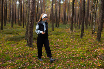 girl in the wood looking for a mushrooms