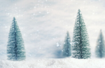 Winter background with a toy Tree in the snow, Christmas background