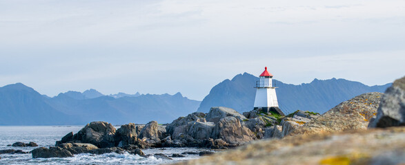 norwegian see with small islands and a picturesque lighthouse