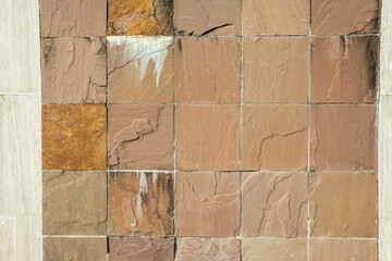 Worn stone mosaics with cracks and calcium carbonate deposits. Worn stone mosaics background