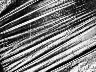 Obraz premium Black and white texture of wrinkled plastic or crumpled plastic of reflecting. Grungy copy space