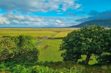 Obraz premium Scenic view of a beautiful landscape with open fields and mountains seen during the day