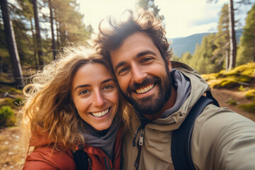 Cute romantic couple taking a selfie while hiking in a forest. Autumn season. Concept of togetherness in nature and wanderlust - Powered by Adobe