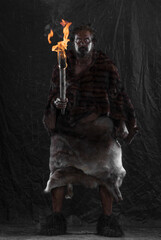 caveman with a torch, black background