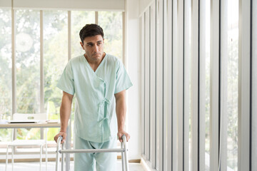 Patient man using walker at hospital ward. Patient man using walker for walk in hospital room