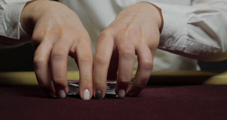Hands of a young caucasian man playing poker in a casino