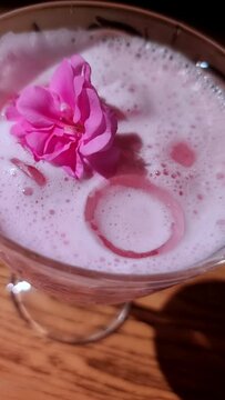 cocktail with foam and pink flower